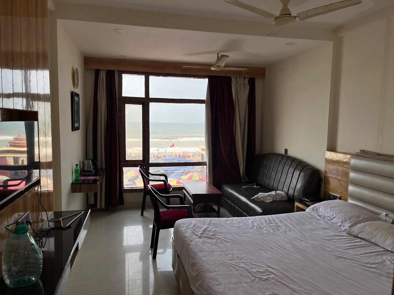 Room interior with a double bed, an additional bed and seating