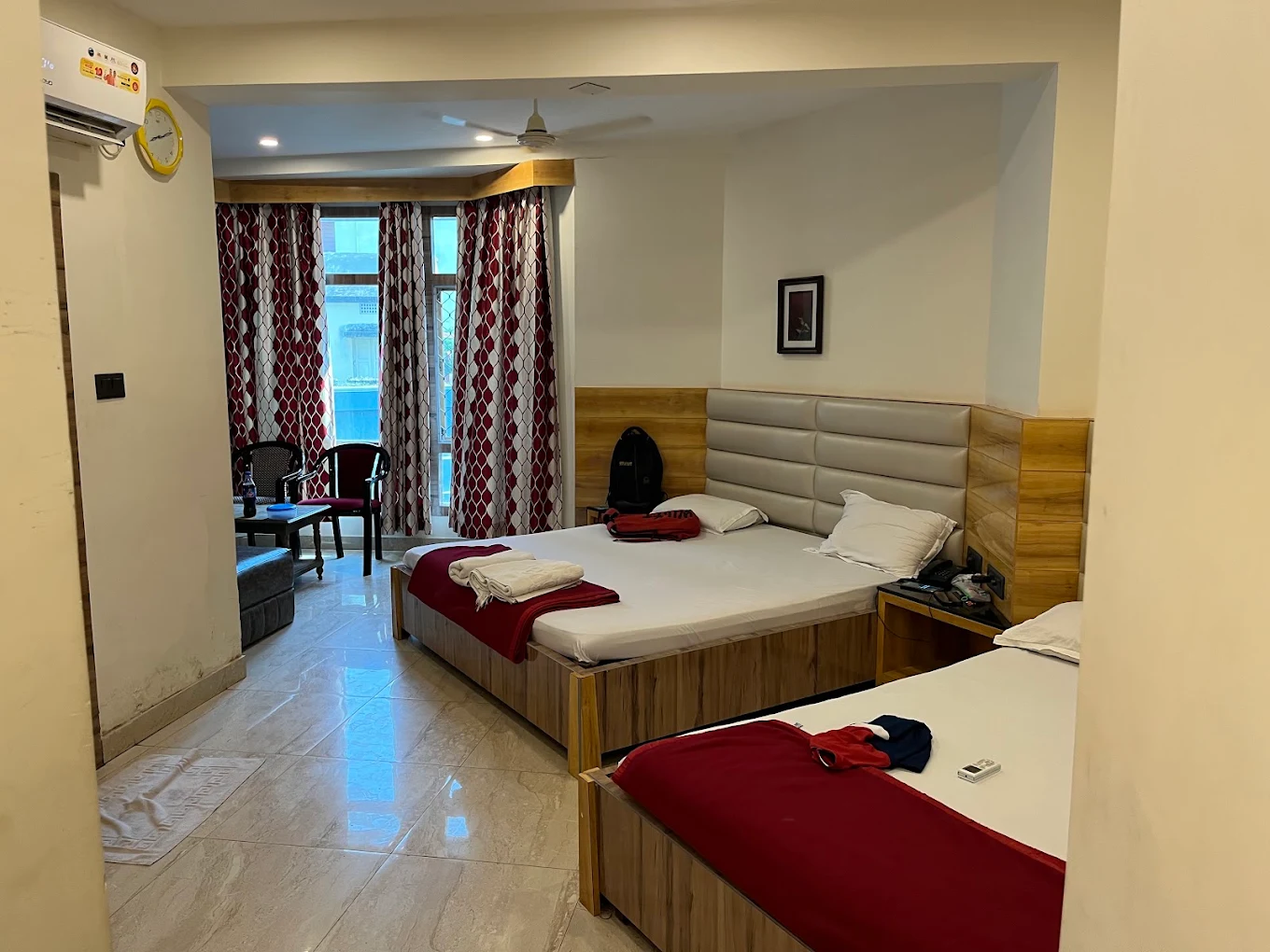 Room with a double bed and seating beside a sea-view window